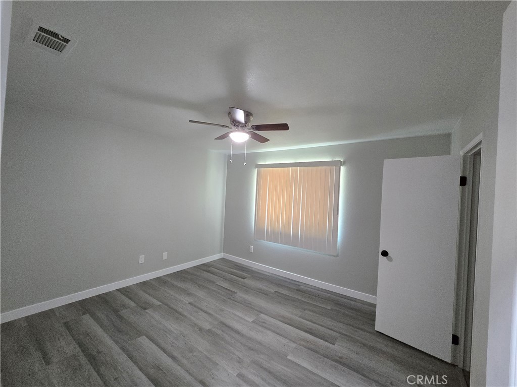 775 Libby Drive Riverside, CA 92507 - Photo 25 of 28 a view of an empty room with wooden floor and a window