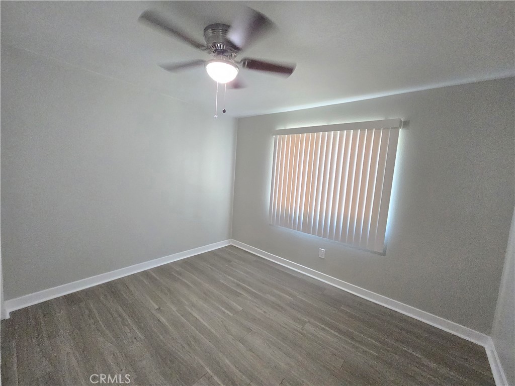 775 Libby Drive Riverside, CA 92507 - Photo 6 of 28 an empty room with wooden floor fan and windows