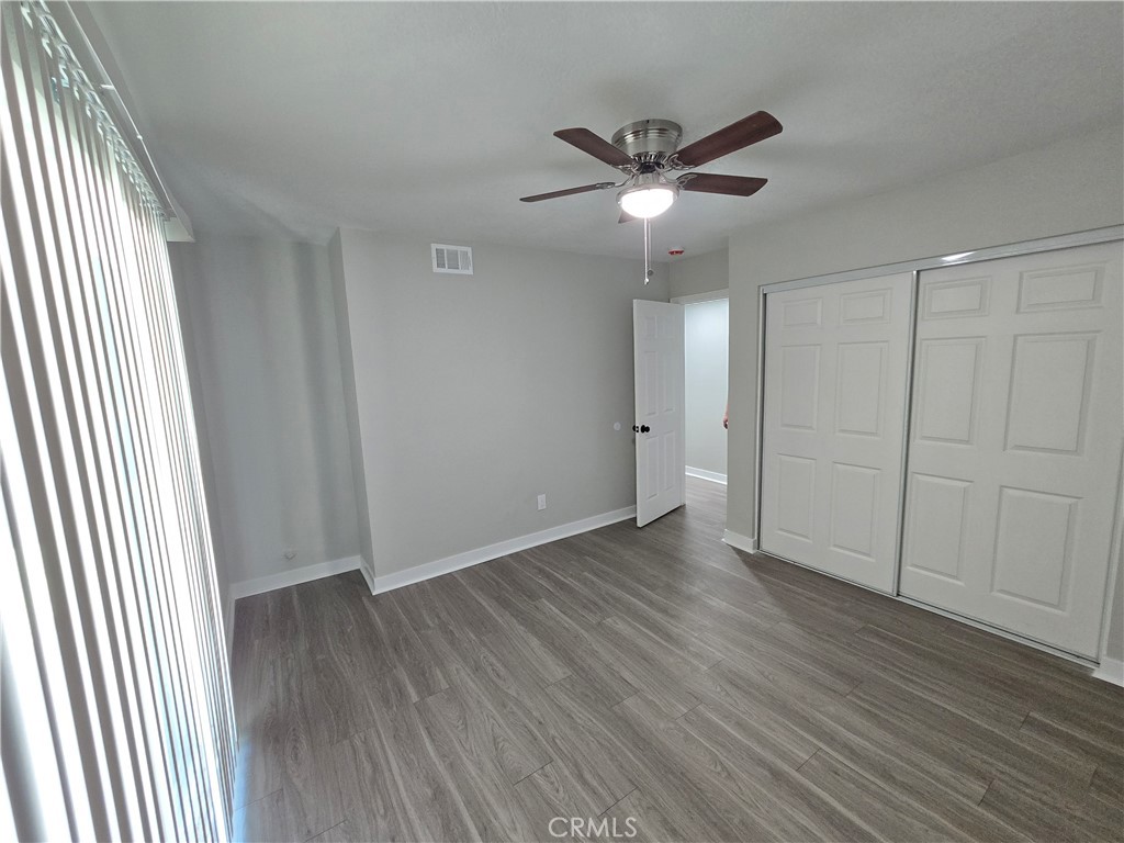 775 Libby Drive Riverside, CA 92507 - Photo 8 of 28 an empty room with wooden floor closet and windows