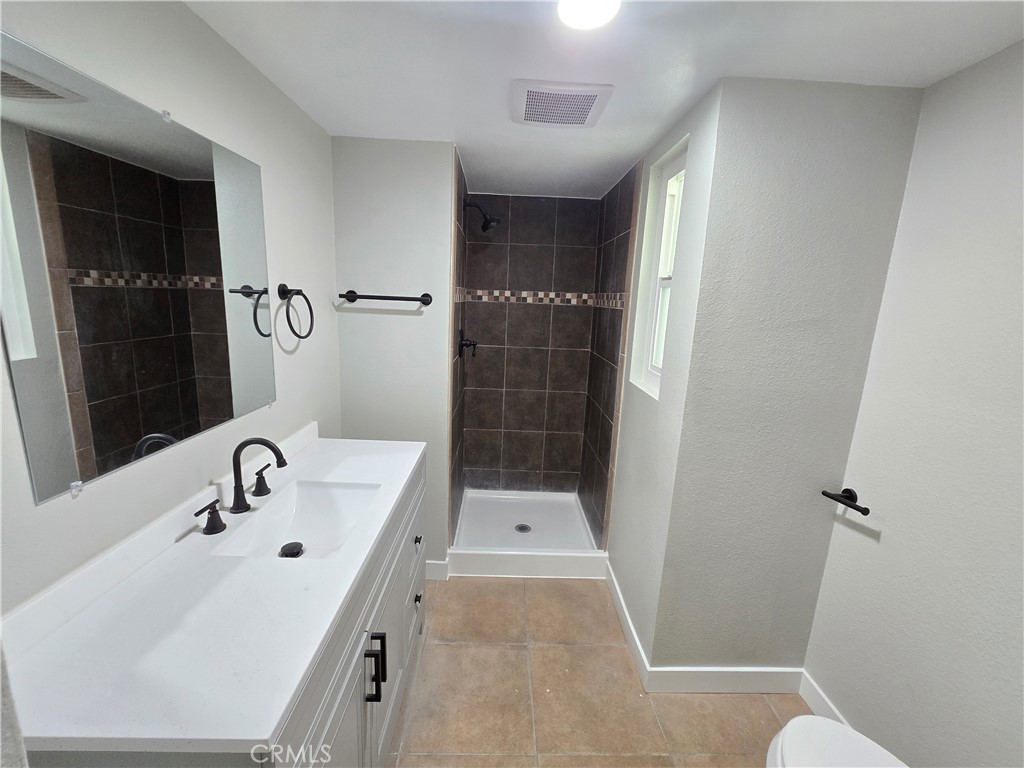 775 Libby Drive Riverside, CA 92507 - Photo 9 of 28 a bathroom with a sink a toilet and shower