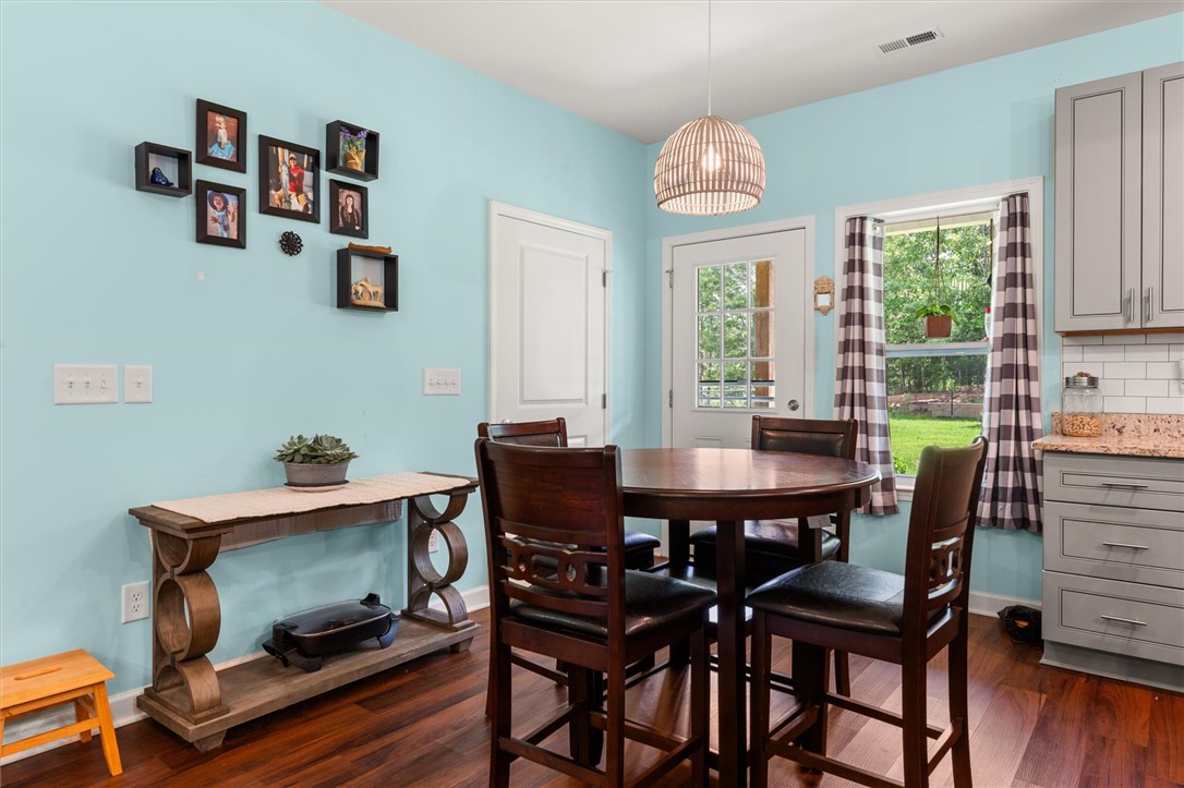 67 Sawblade Ridge Marietta, SC 29661 - Photo 13 of 37 This bright eat-in kitchen features rich wood flooring, a casual dining area, and a functional layout.