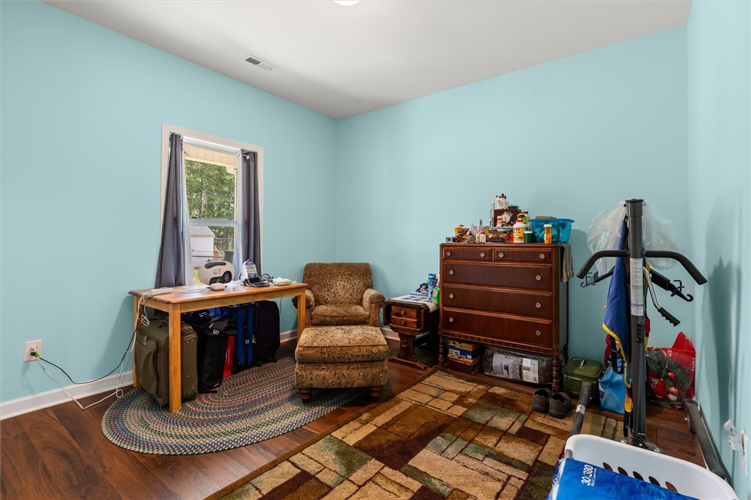 67 Sawblade Ridge Marietta, SC 29661 - Photo 21 of 37 Bright and airy, this cozy room features durable wood flooring, offering a comfortable and inviting atmosphere.