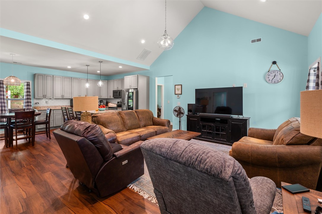 67 Sawblade Ridge Marietta, SC 29661 - Photo 8 of 37 This inviting space features an open concept design with vaulted ceilings and gleaming hardwood floors.