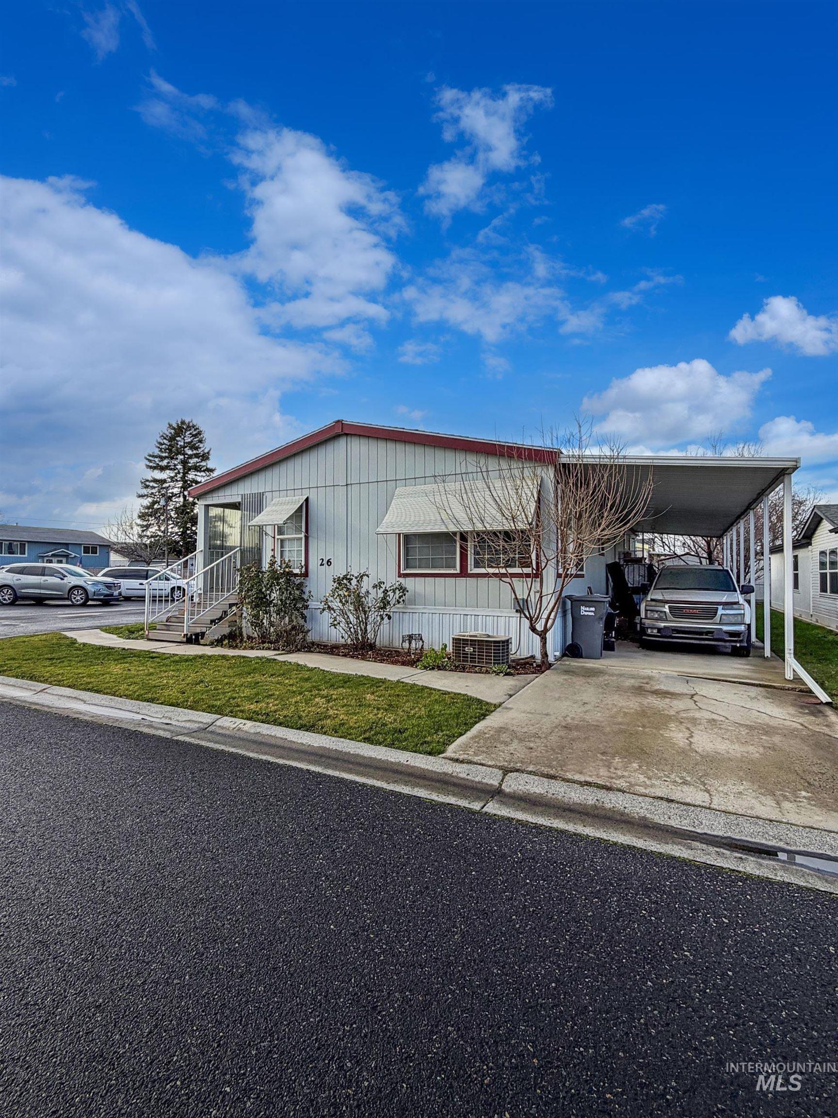 2115 6th Avenue, Unit 26 Clarkston, WA 99403 - Photo 2 of 5 Manufactured / mobile home featuring an attached carport and concrete driveway
