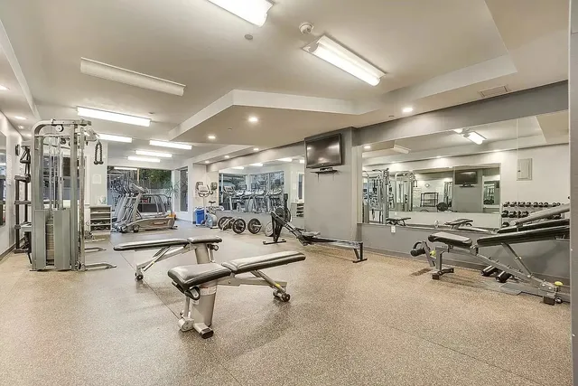 a room with gym equipment and view of counter top