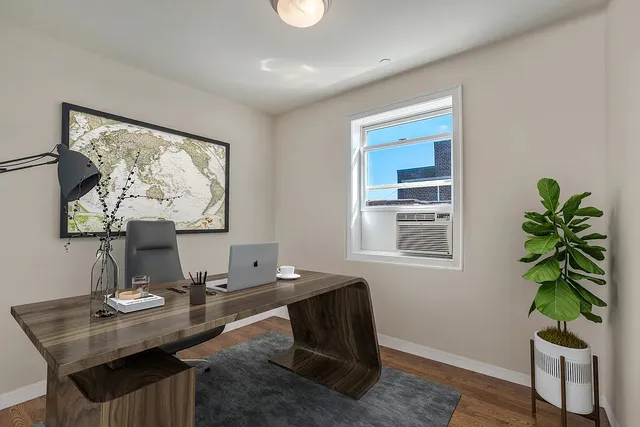 a living room with furniture and a potted plant