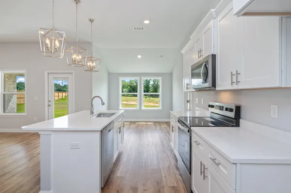 a kitchen with a sink stove and microwave