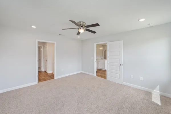 a view of a livingroom with a ceiling fan and window