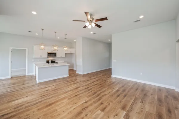 a view of kitchen with cabinets and wooden floor