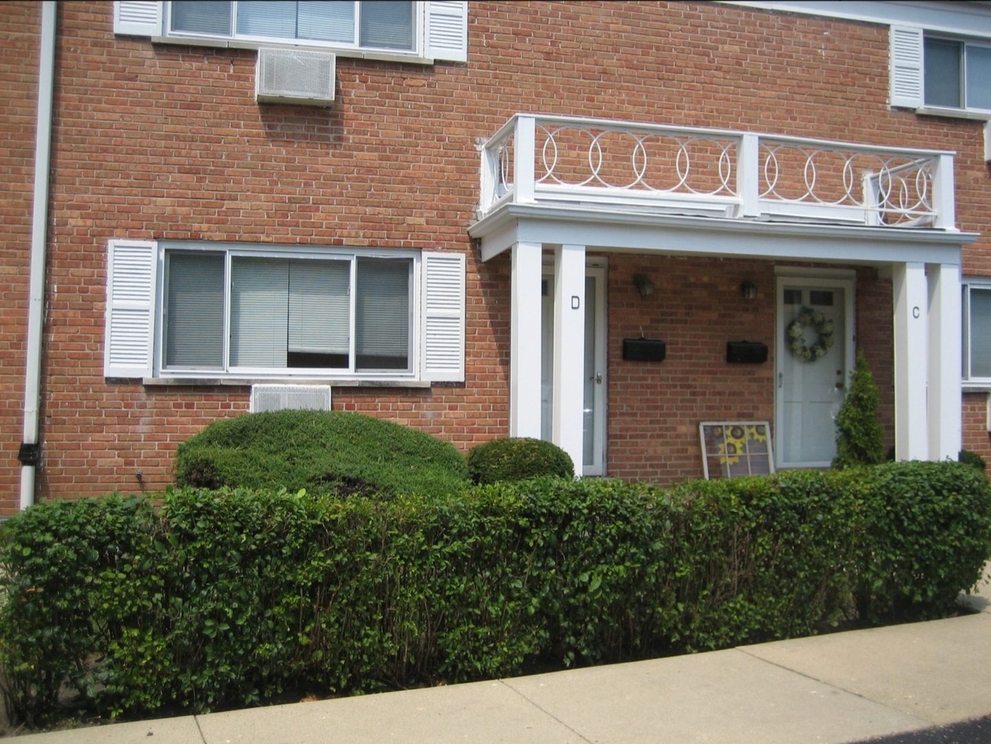 front view of a brick house with a large windows