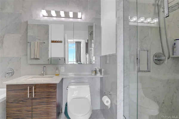 a bedroom with a bed and a flat tv screen on the dresser