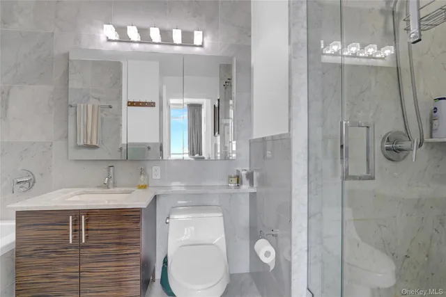 a bedroom with a bed and a flat tv screen on the dresser