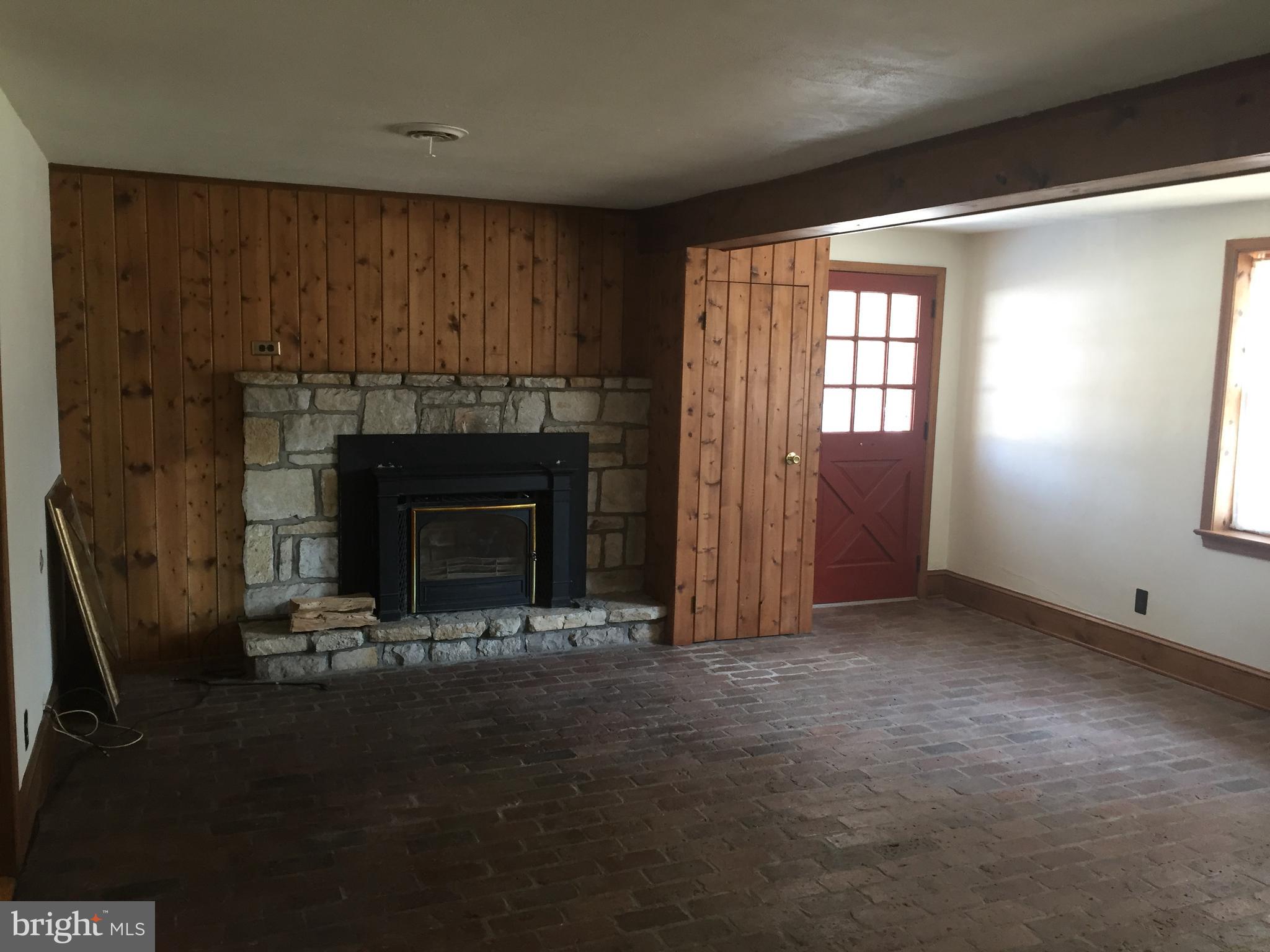 1609 Kimberton Road Chester Springs, PA 19425 - Photo 9 of 30 Family room with stone fireplace and brick floor