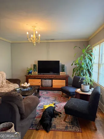 a living room with furniture and a flat screen tv