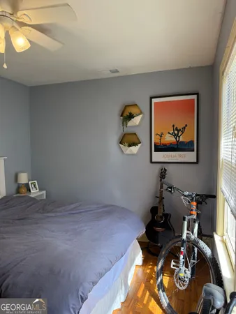 a bedroom with bed and painting on the wall