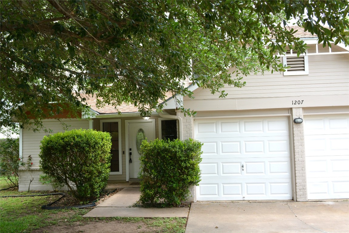 1207 Crupp Court Austin, TX 78753 - Photo 1 of 11 front view of a house and a tree