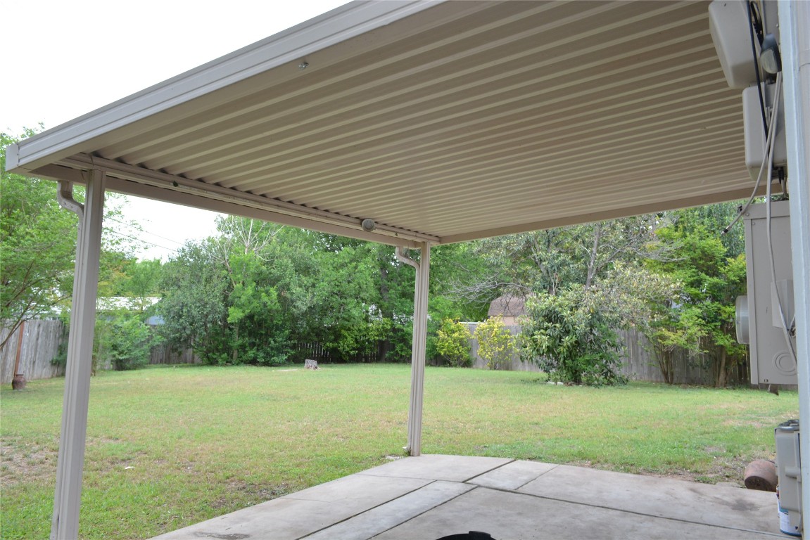 1207 Crupp Court Austin, TX 78753 - Photo 11 of 11 a backyard of a house with a garden and outdoor seating