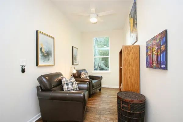a living room with furniture a large window and a flat screen tv