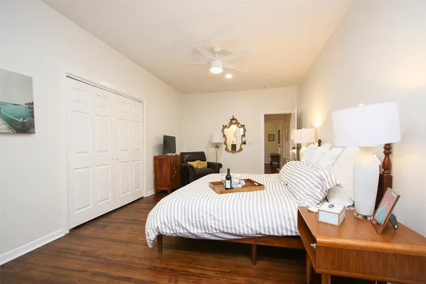 a bedroom with a bed and wooden floor