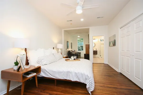 a bedroom with a bed and wooden floor