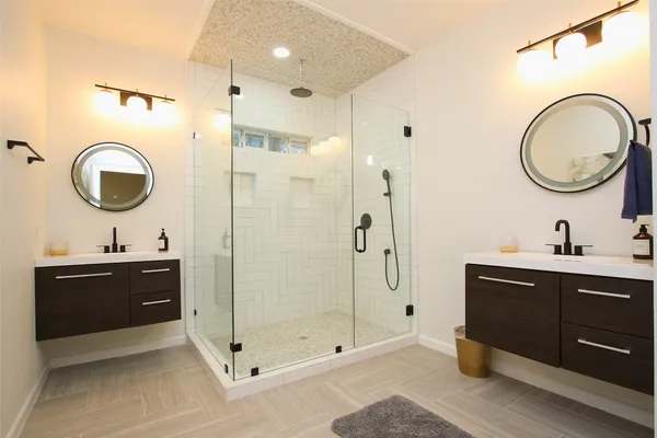 a bathroom with a sink a toilet and a mirror