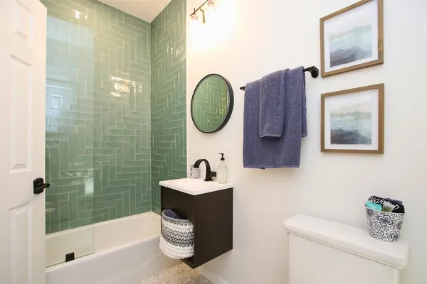 a bathroom with a sink a toilet and shower