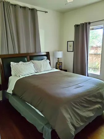 a bedroom with a bed and window