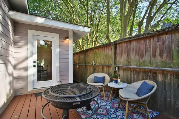 a backyard of a house with table and chairs