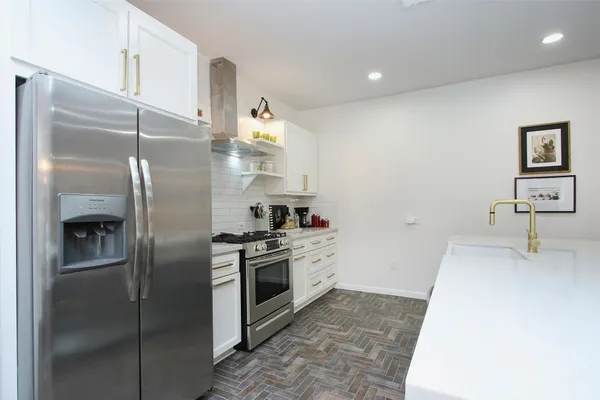 a kitchen with a refrigerator and a sink
