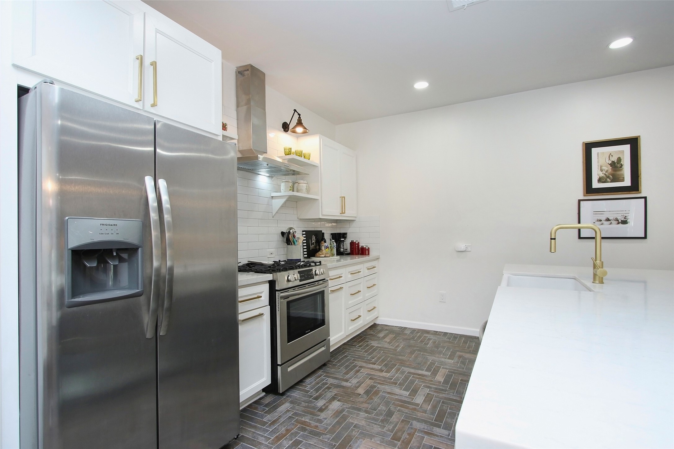 1818 Haver Street Houston, TX 77006 - Photo 5 of 28 a kitchen with a refrigerator and a sink