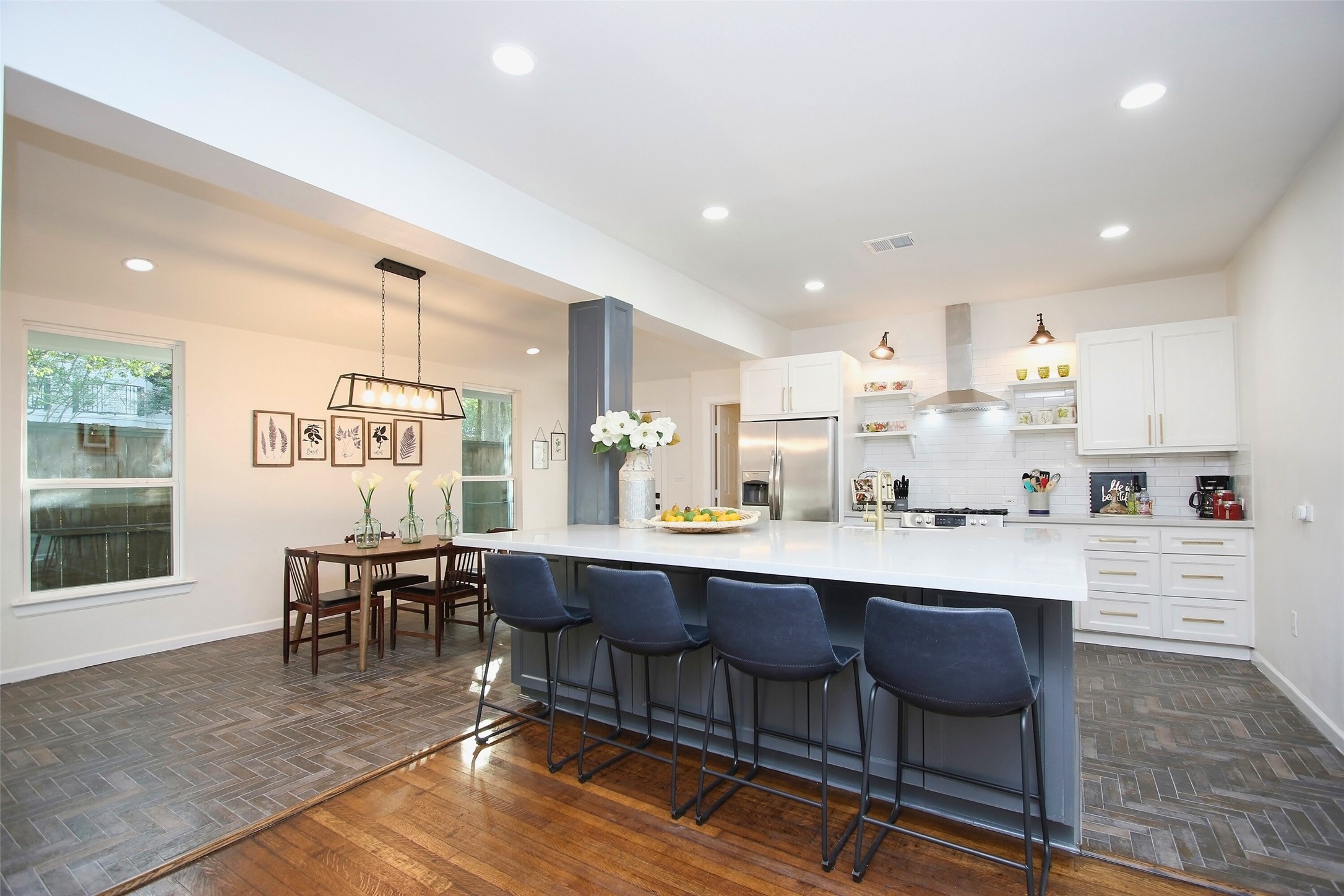 1818 Haver Street Houston, TX 77006 - Photo 6 of 28 a dining hall with stainless steel appliances granite countertop a table chairs and a living room view