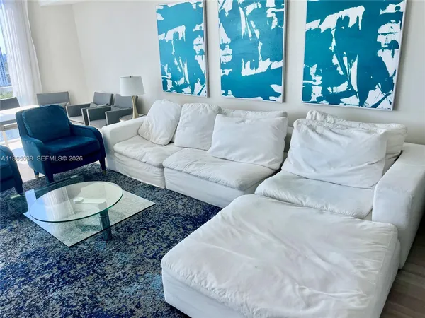 a living room with furniture and a large window