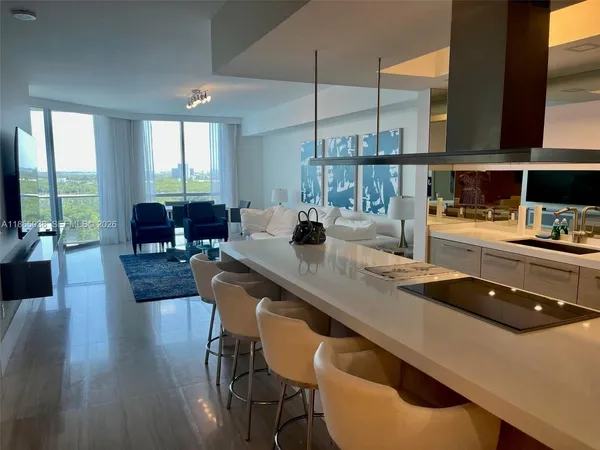 a kitchen with a table chairs stove and wooden floor