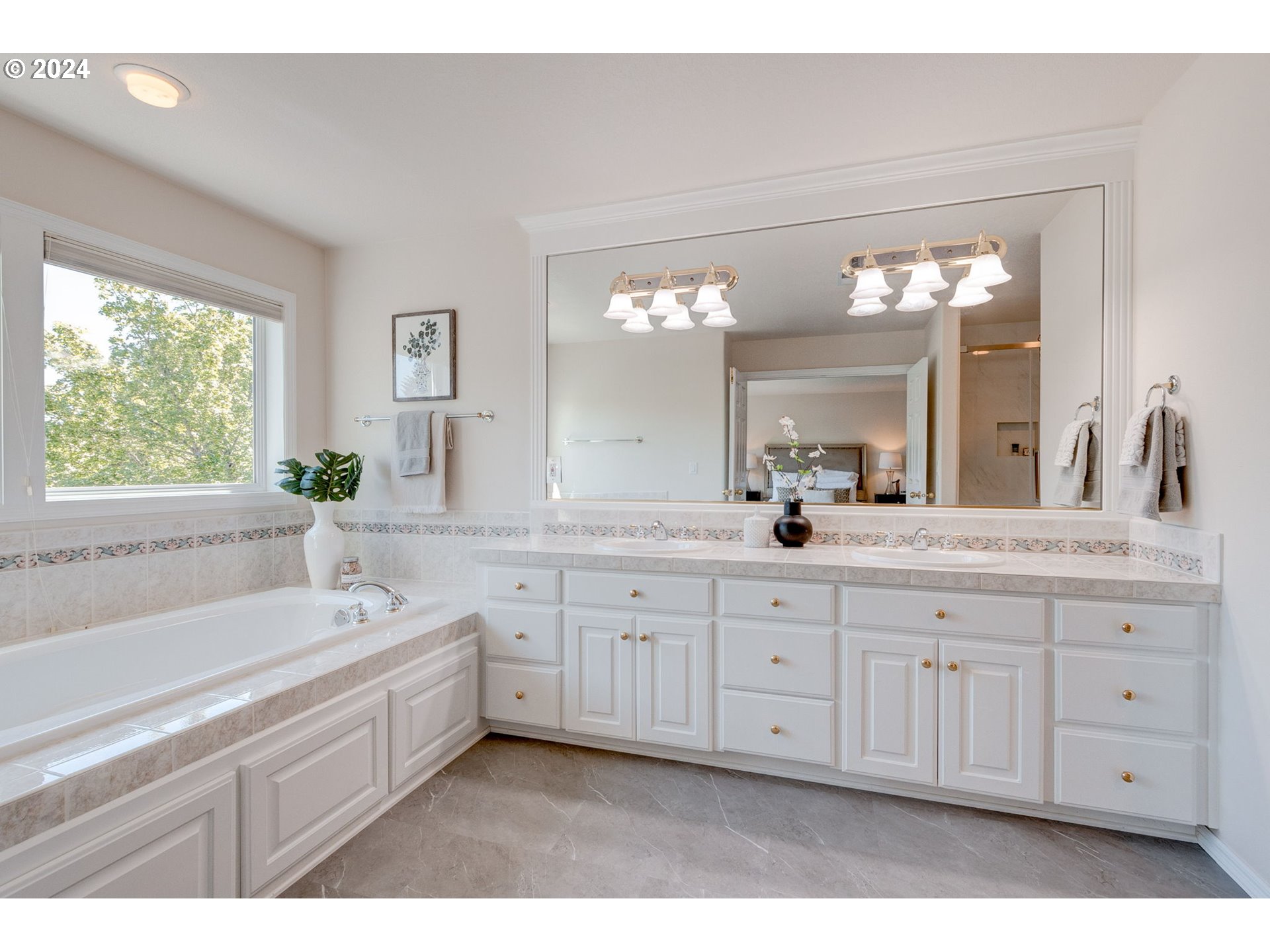 16610 Northwest Mission Oaks Drive Beaverton, OR 97006 - Photo 23 of 37 a spacious bathroom with a granite countertop sink mirror and a bathtub