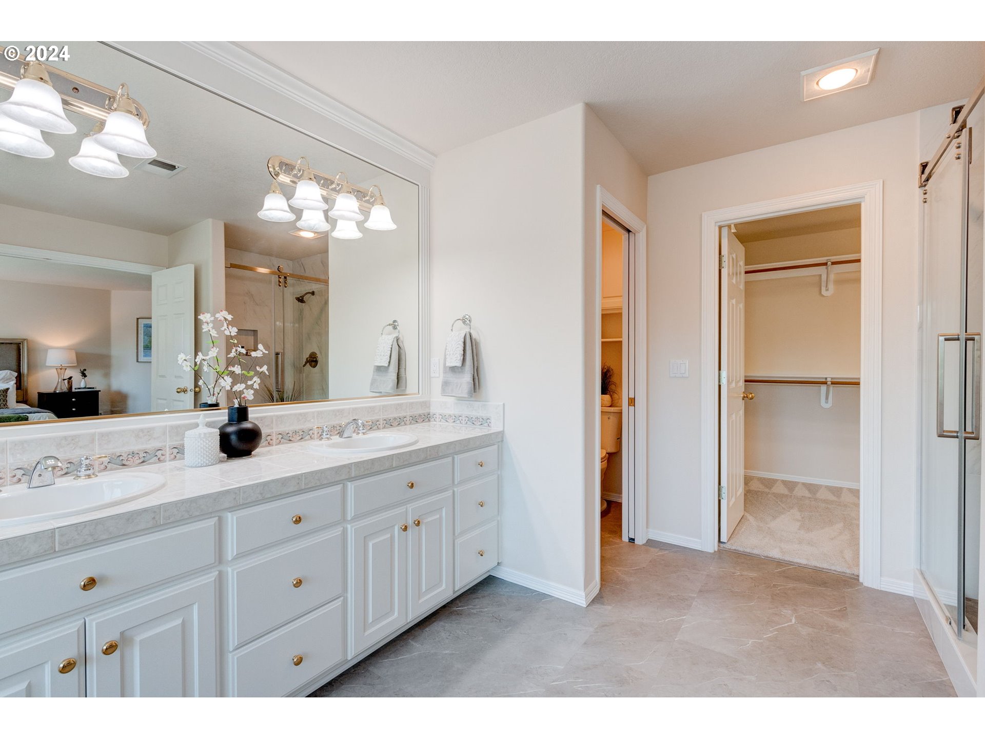 16610 Northwest Mission Oaks Drive Beaverton, OR 97006 - Photo 25 of 37 a bathroom with a double vanity sink and a mirror