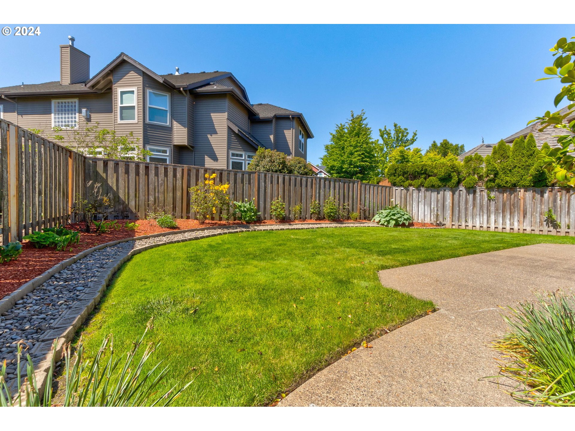 16610 Northwest Mission Oaks Drive Beaverton, OR 97006 - Photo 32 of 37 a view of a house with a yard and wooden fence