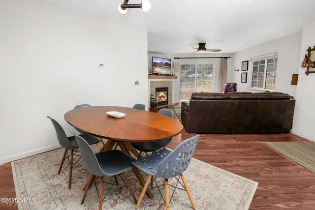 a living room with a table and a fireplace