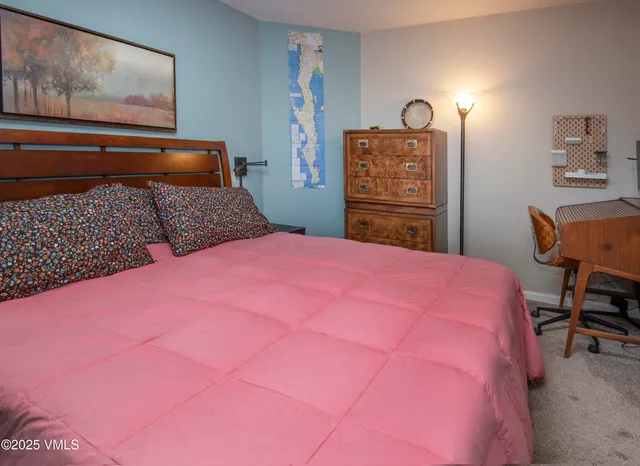 a bathroom with a granite countertop sink mirror vanity and toilet