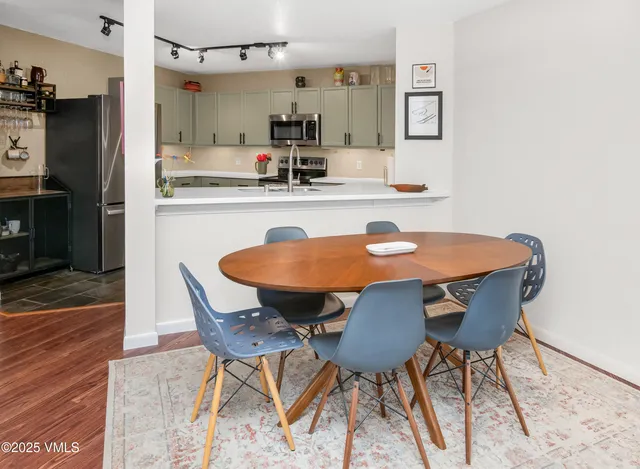 a dining room with furniture and wooden floor