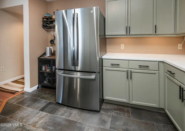 a kitchen with appliances and a refrigerator