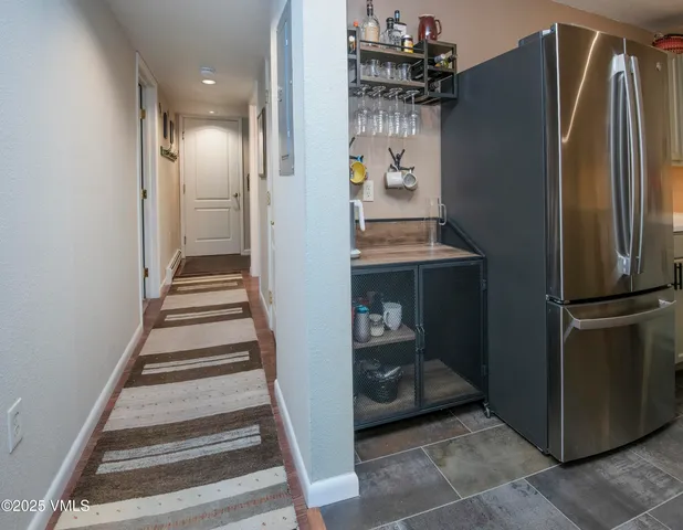 a view of a kitchen with refrigerator and cabinets