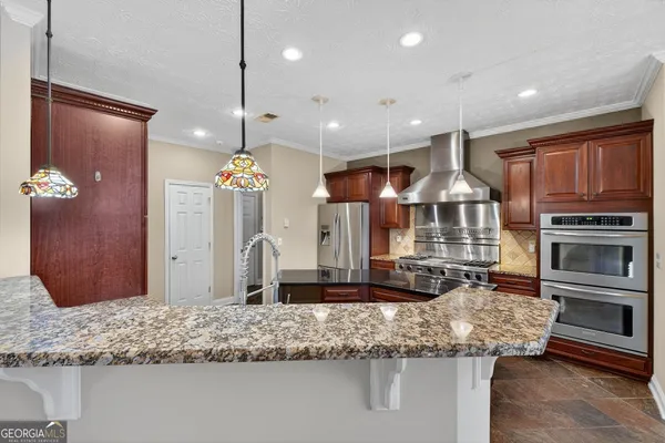 a kitchen with stainless steel appliances kitchen island granite countertop a granite counter tops and wooden cabinets
