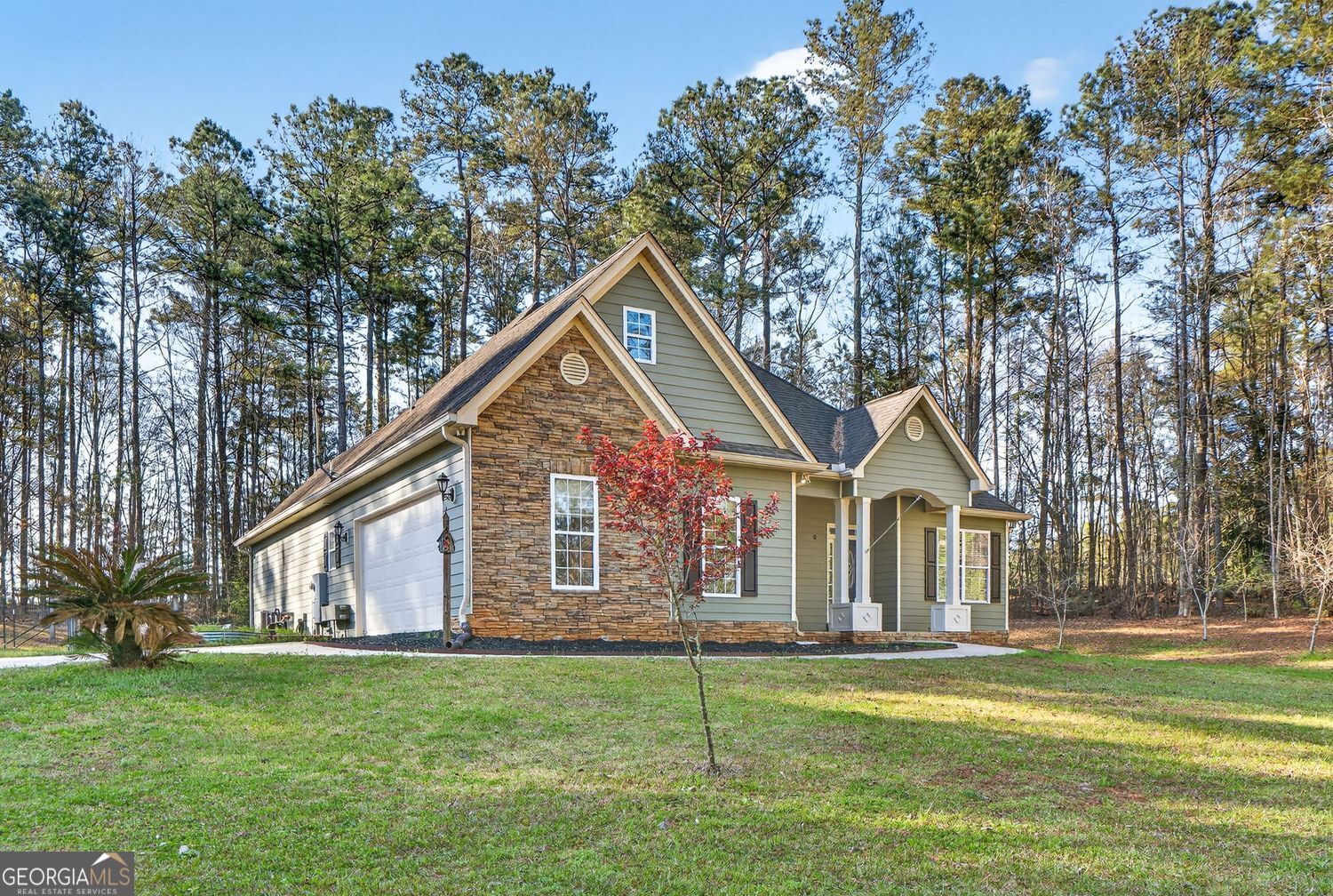 206 Jack Maddox Bridge Road Jackson, GA 30233 - Photo 3 of 38 a front view of a house with a garden and trees