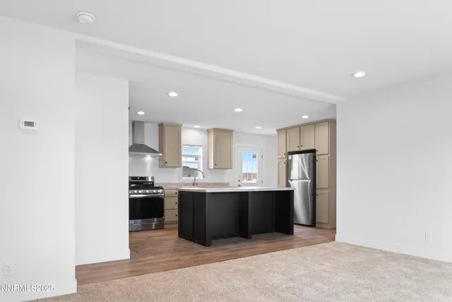a large kitchen with stainless steel appliances granite countertop a sink and cabinets
