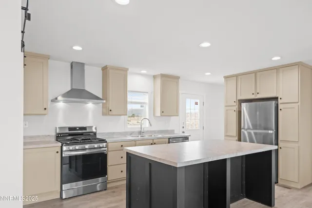 a kitchen with stainless steel appliances a sink stove and refrigerator