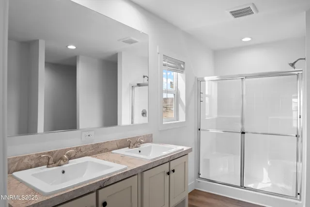 a bathroom with a double vanity sink mirror and double