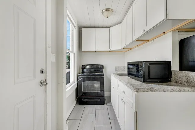 a kitchen with stainless steel appliances a stove microwave and cabinets