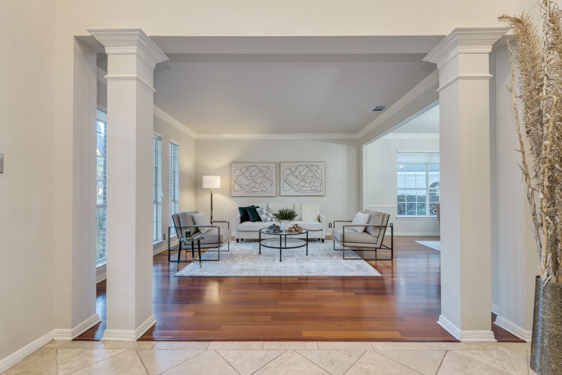 10701 Redmond Road Austin, TX 78739 - Photo 12 of 39 a view of dining room and livingroom with furniture wooden floor and a rug