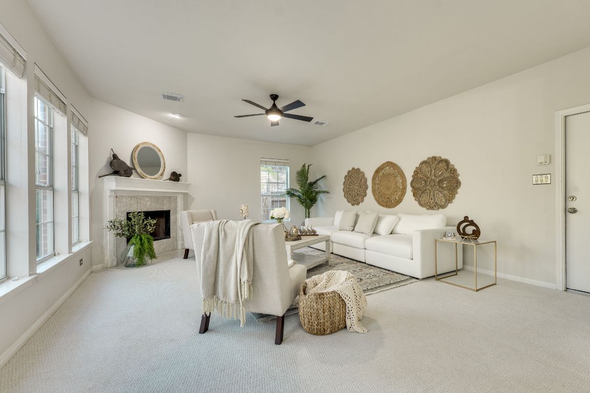 10701 Redmond Road Austin, TX 78739 - Photo 20 of 39 a living room with furniture a fireplace and a window