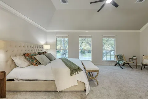 a bedroom with a bed and a chandelier